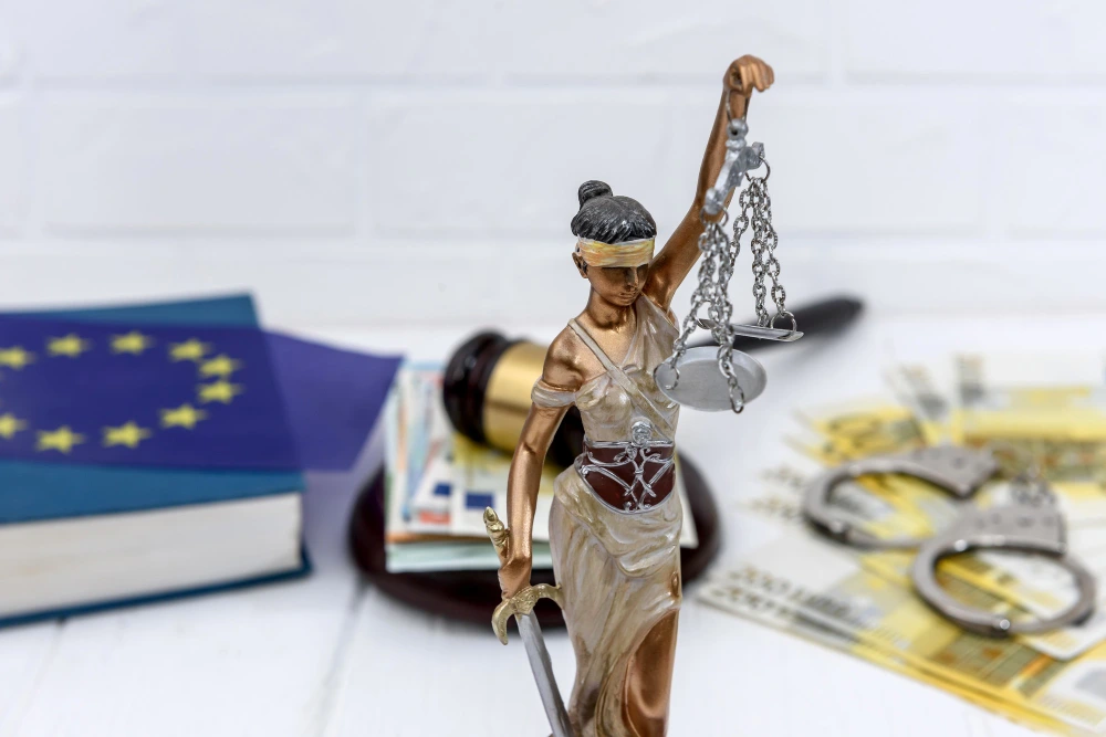 Exoneración de deuda pública representada por mazo judicial y banderas de España y la Unión Europea
